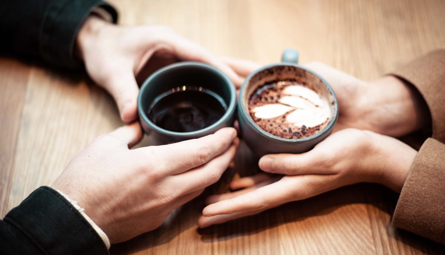 hands holding coffee